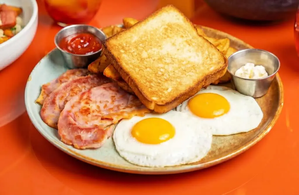 OEB Classic Breakfast with eggs, bacon, toast, and potatoes